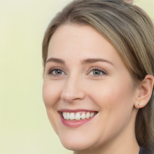 Joyful white young-adult female with long  brown hair and green eyes