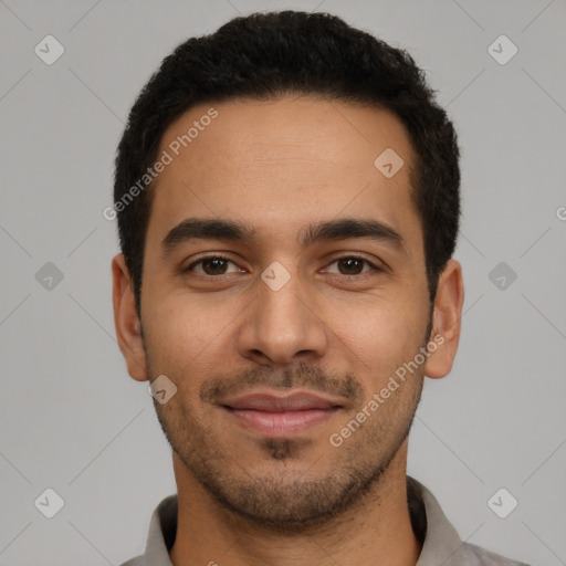 Joyful latino young-adult male with short  black hair and brown eyes