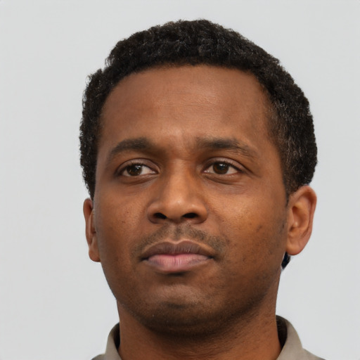 Neutral black young-adult male with short  black hair and brown eyes