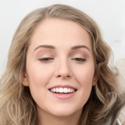 Joyful white young-adult female with long  brown hair and blue eyes