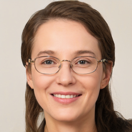 Joyful white adult female with medium  brown hair and grey eyes