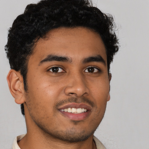 Joyful latino young-adult male with short  brown hair and brown eyes