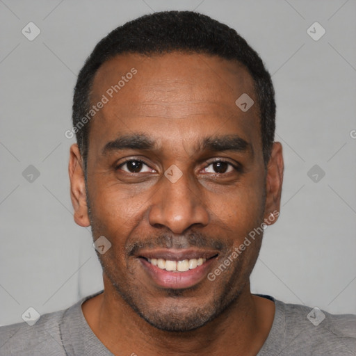 Joyful black young-adult male with short  black hair and brown eyes