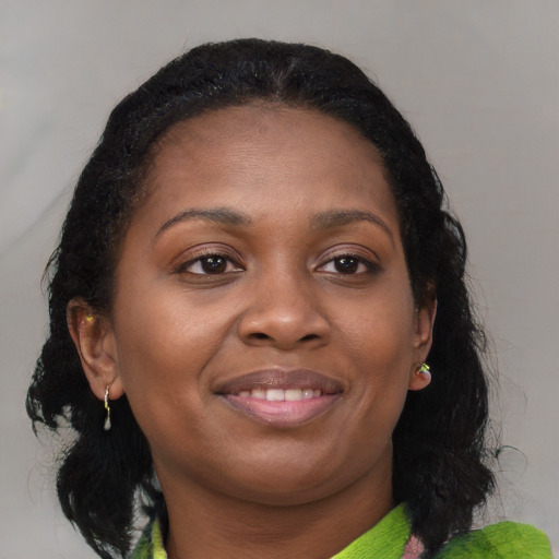 Joyful black young-adult female with medium  black hair and brown eyes