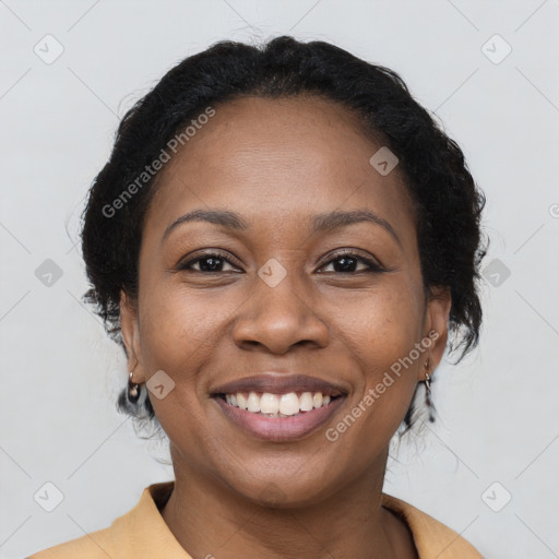 Joyful black young-adult female with medium  brown hair and brown eyes