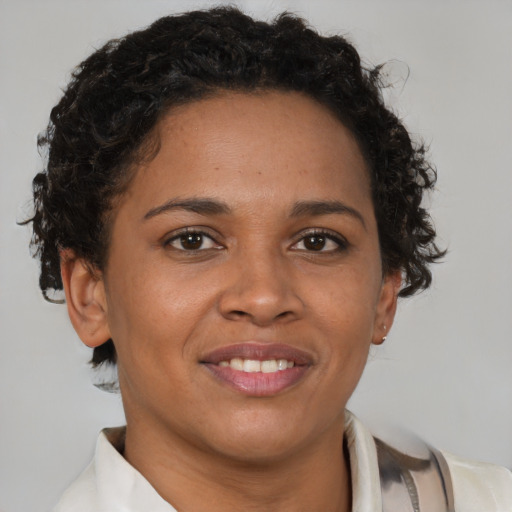 Joyful latino adult female with short  brown hair and brown eyes