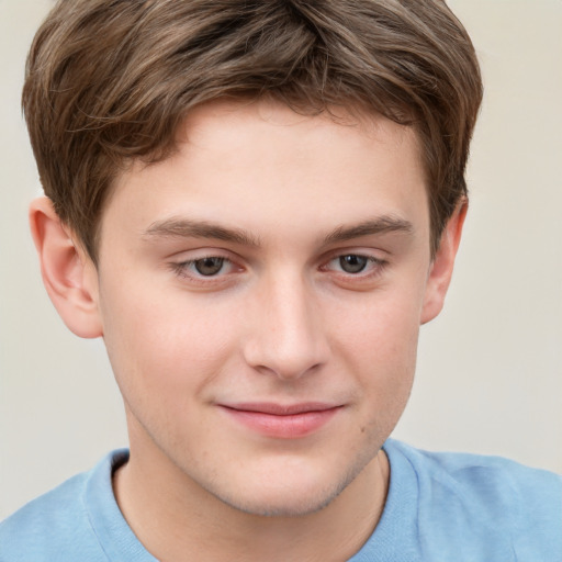 Joyful white child male with short  brown hair and grey eyes