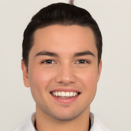 Joyful white young-adult male with short  black hair and brown eyes