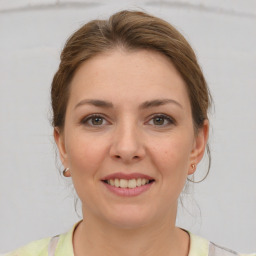 Joyful white young-adult female with medium  brown hair and brown eyes