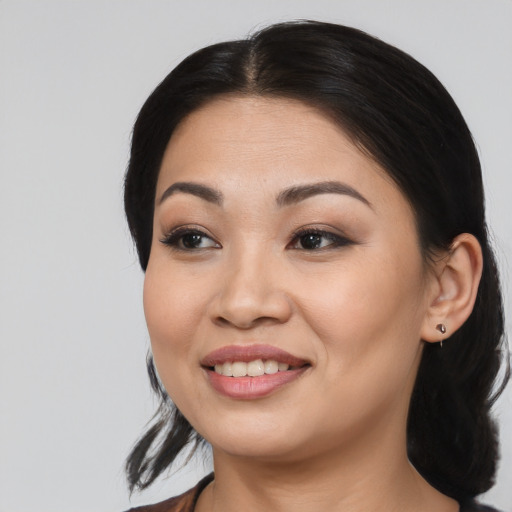 Joyful asian young-adult female with long  black hair and brown eyes