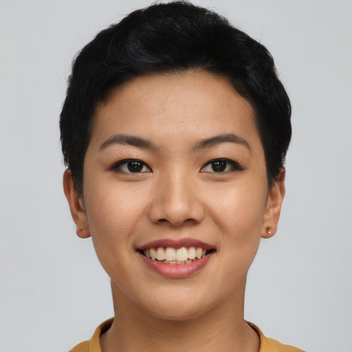 Joyful asian young-adult female with short  black hair and brown eyes