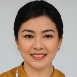 Joyful asian young-adult female with short  brown hair and brown eyes