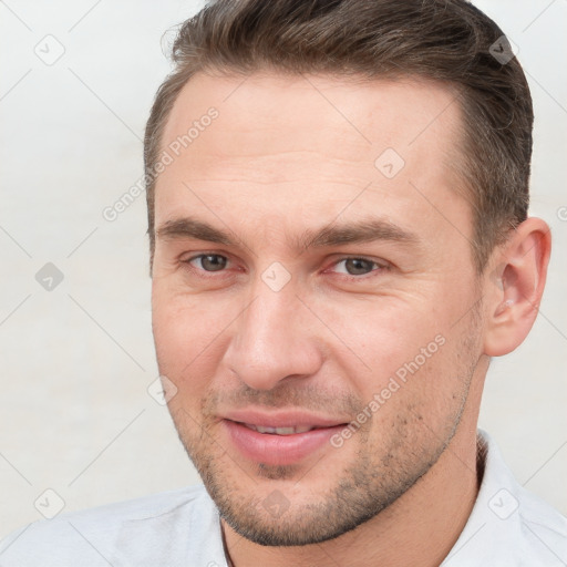 Joyful white young-adult male with short  brown hair and brown eyes