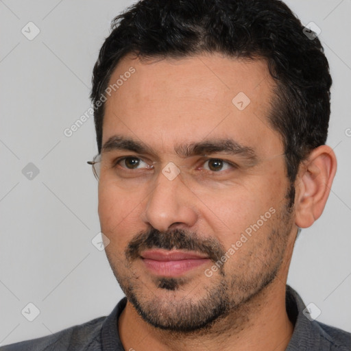 Joyful white adult male with short  black hair and brown eyes