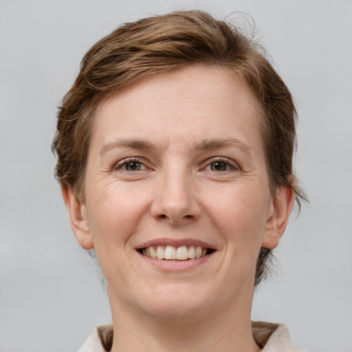 Joyful white young-adult female with medium  brown hair and grey eyes