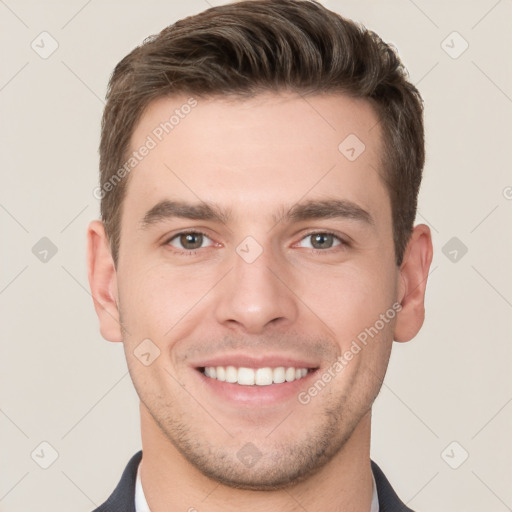 Joyful white young-adult male with short  brown hair and grey eyes