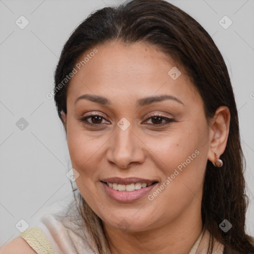Joyful white adult female with long  brown hair and brown eyes
