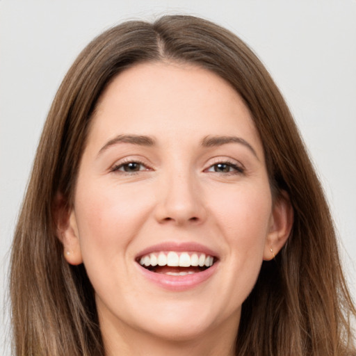 Joyful white young-adult female with long  brown hair and brown eyes