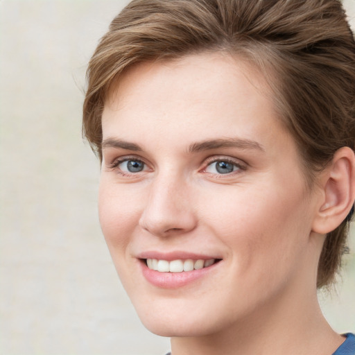 Joyful white young-adult female with medium  brown hair and blue eyes