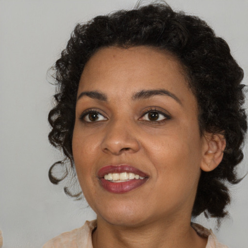 Joyful black young-adult female with medium  black hair and brown eyes