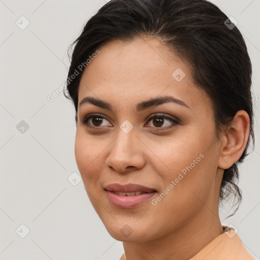 Joyful latino young-adult female with short  brown hair and brown eyes