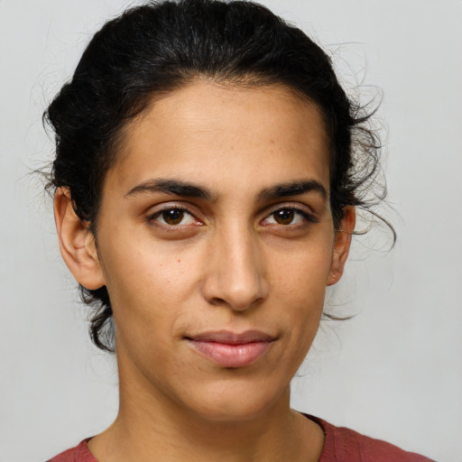 Joyful latino young-adult female with short  brown hair and brown eyes