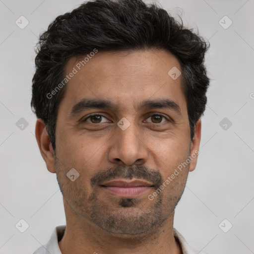 Joyful white adult male with short  black hair and brown eyes