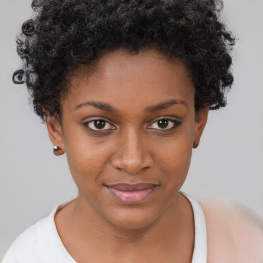 Joyful black young-adult female with short  brown hair and brown eyes
