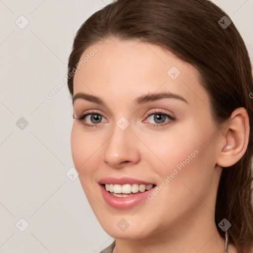 Joyful white young-adult female with long  brown hair and grey eyes