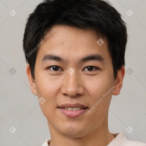 Joyful asian young-adult male with short  brown hair and brown eyes