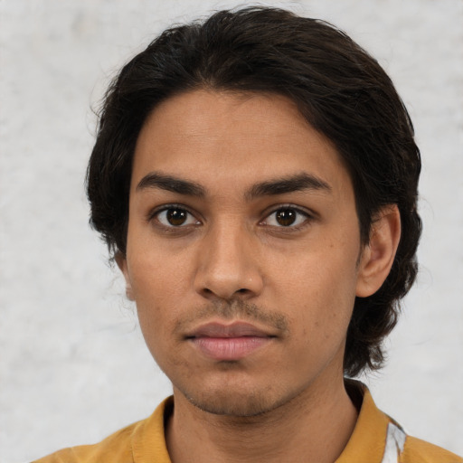 Neutral latino young-adult male with short  brown hair and brown eyes