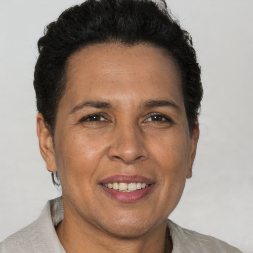 Joyful latino adult female with short  brown hair and brown eyes