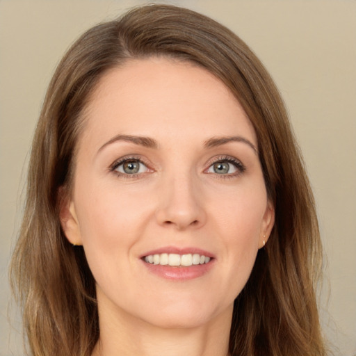 Joyful white young-adult female with long  brown hair and green eyes