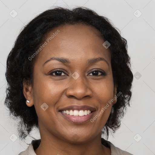 Joyful black adult female with medium  brown hair and brown eyes