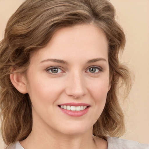 Joyful white young-adult female with medium  brown hair and green eyes