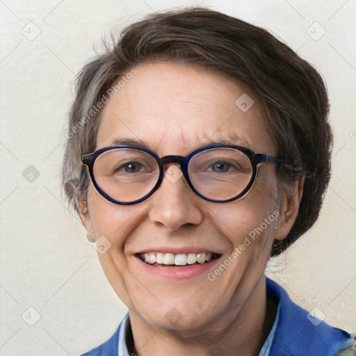 Joyful white adult female with short  brown hair and blue eyes