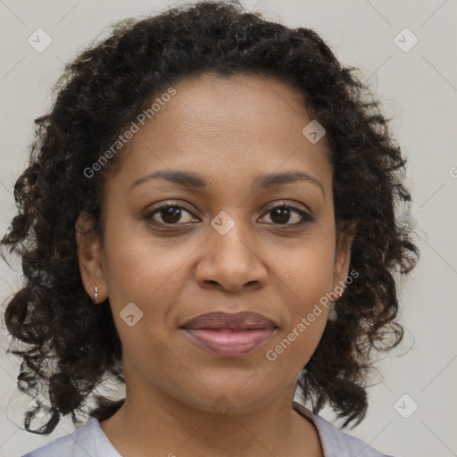 Joyful black adult female with medium  brown hair and brown eyes