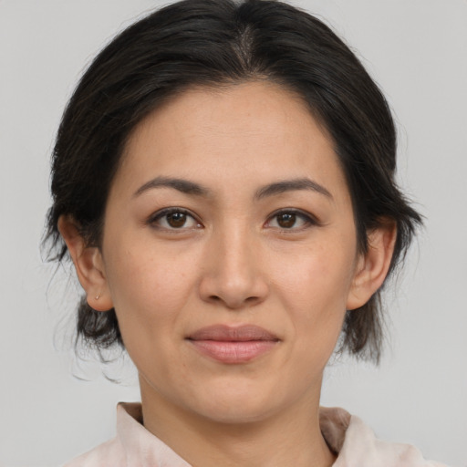 Joyful asian adult female with medium  brown hair and brown eyes