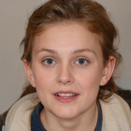 Joyful white young-adult female with medium  brown hair and blue eyes