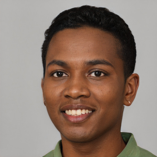 Joyful black young-adult male with short  black hair and brown eyes