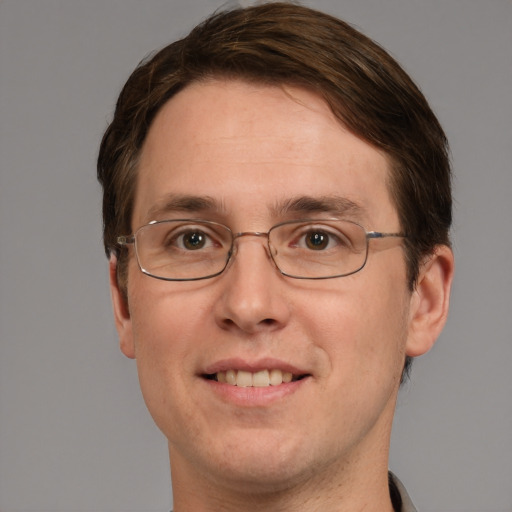 Joyful white adult male with short  brown hair and grey eyes