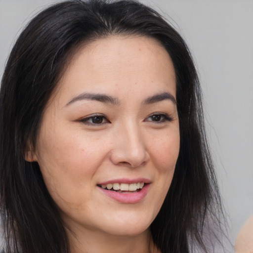 Joyful asian young-adult female with long  brown hair and brown eyes