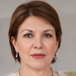 Joyful white adult female with medium  brown hair and grey eyes