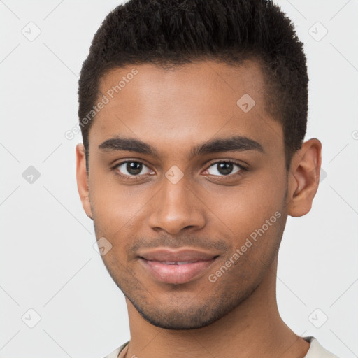 Joyful black young-adult male with short  brown hair and brown eyes