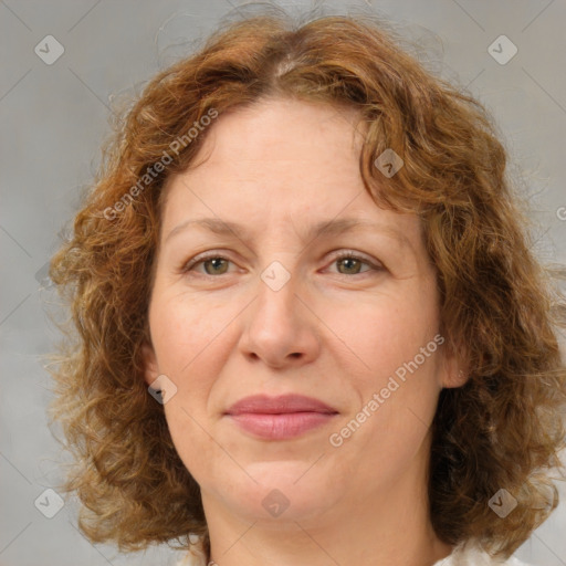 Joyful white adult female with medium  brown hair and green eyes