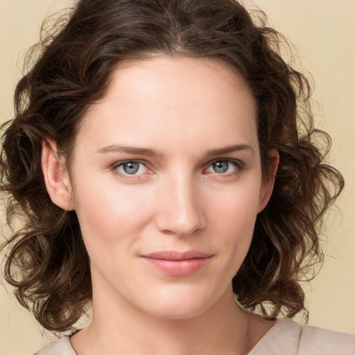 Joyful white young-adult female with medium  brown hair and green eyes