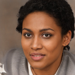 Joyful black young-adult female with long  brown hair and brown eyes