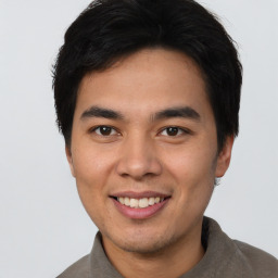 Joyful asian young-adult male with short  brown hair and brown eyes