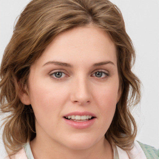 Joyful white young-adult female with medium  brown hair and green eyes