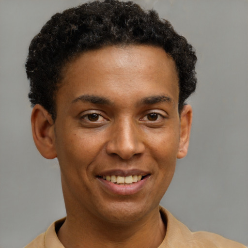 Joyful latino young-adult male with short  brown hair and brown eyes